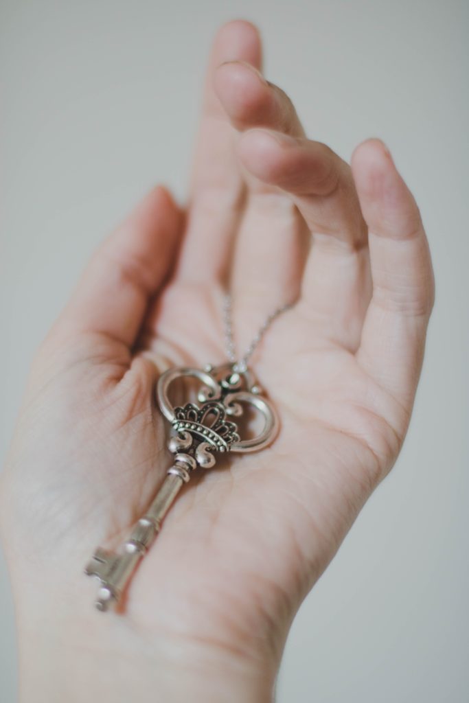 Hand holding an antique key