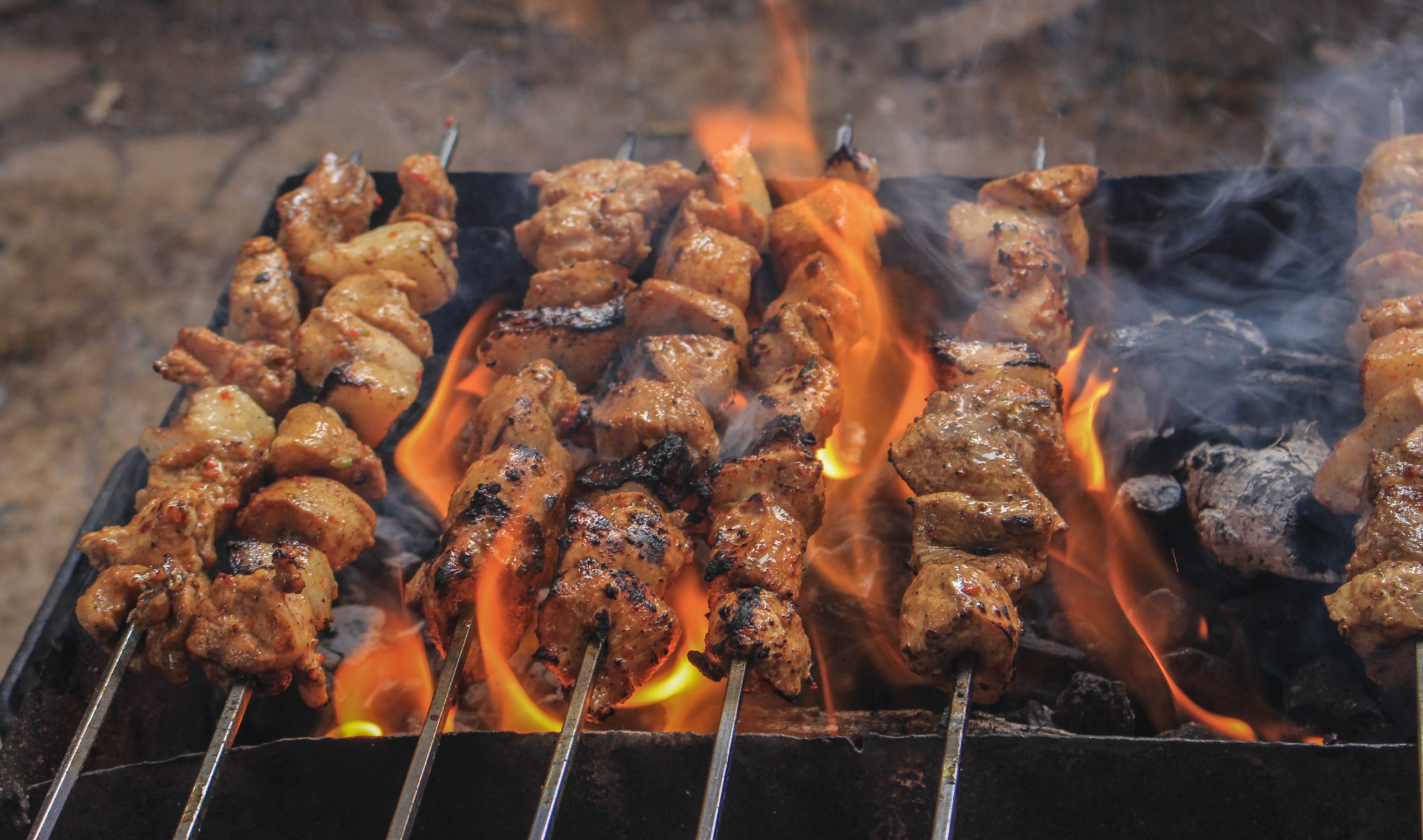 Photo of grilled meat on skewers