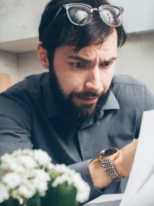 man in black long sleeve shirt wearing gold watch
